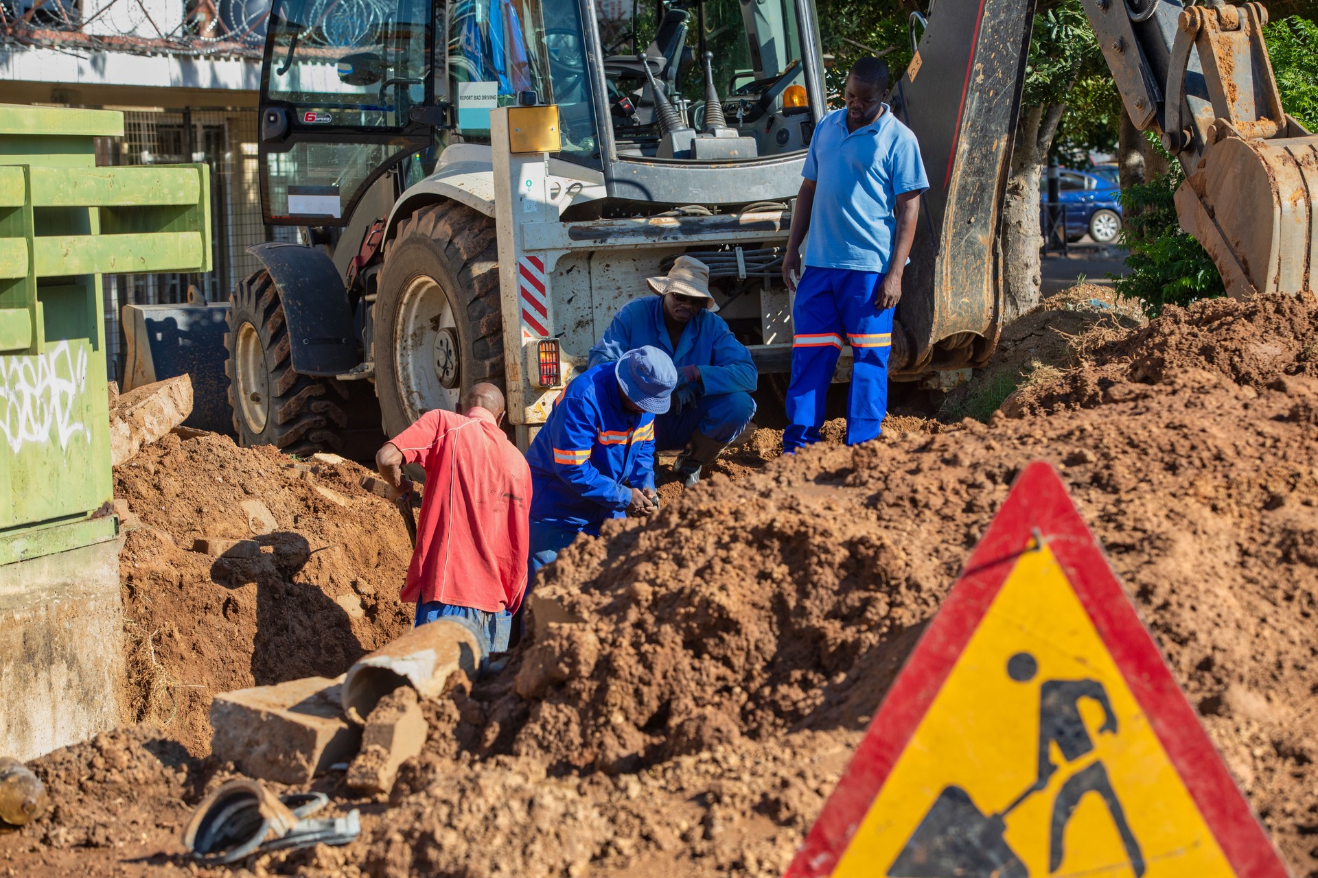 African repairman attending to the city water supply